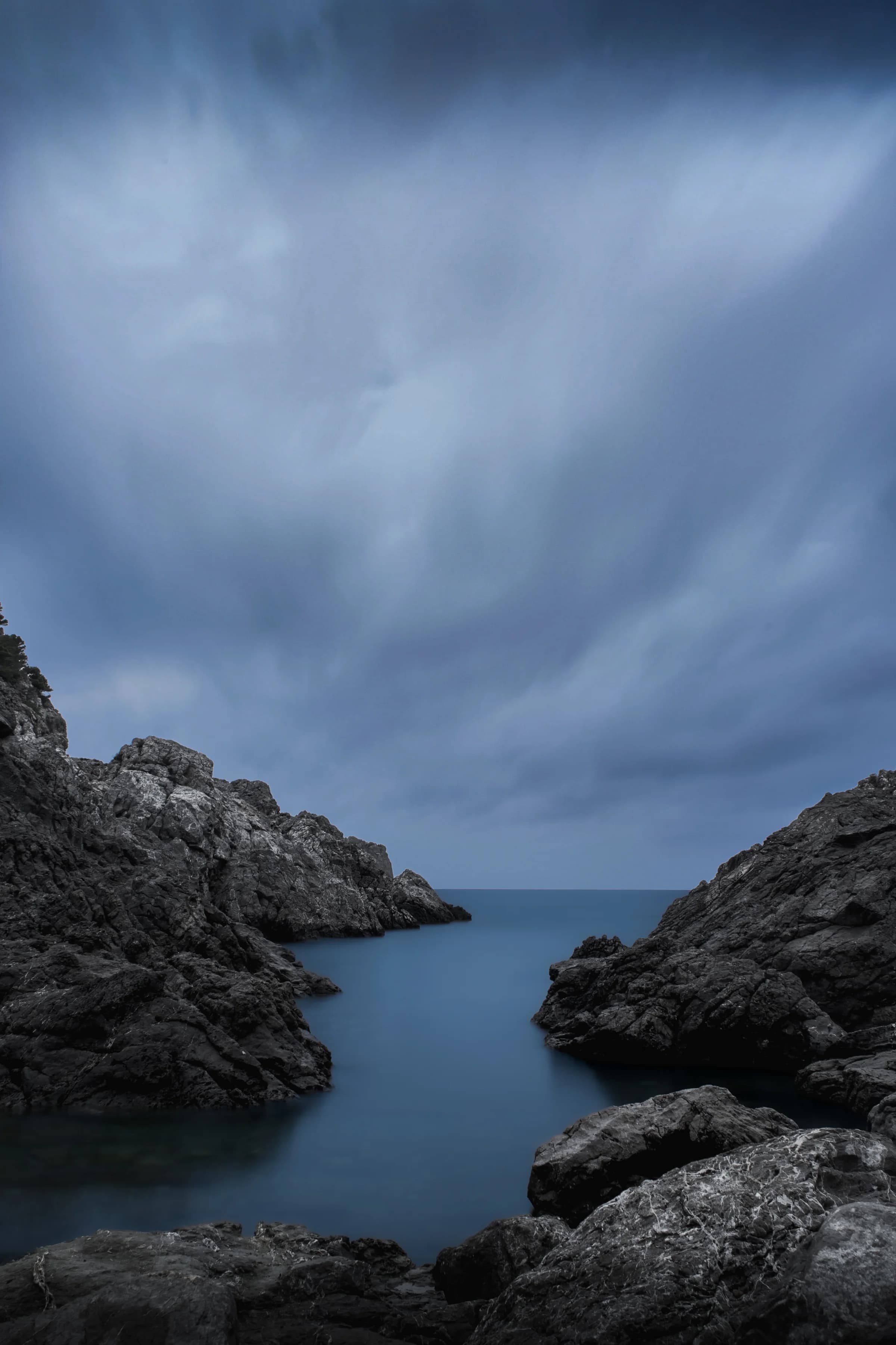 A dark rocky cove opening into the sea near Torroella de Montgrí