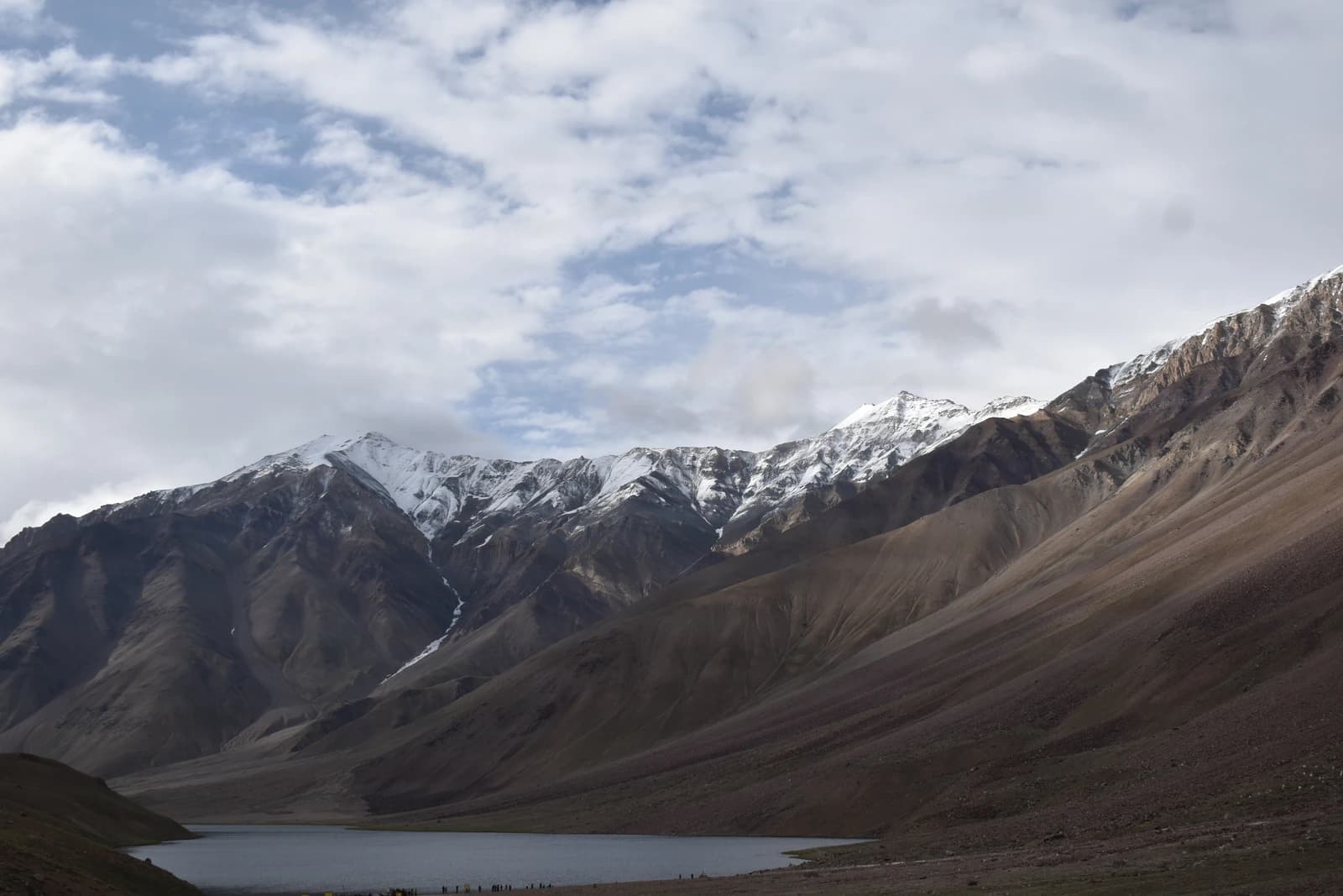 Barren peaks frame a glacial lake nestled in austere mountain solitude.